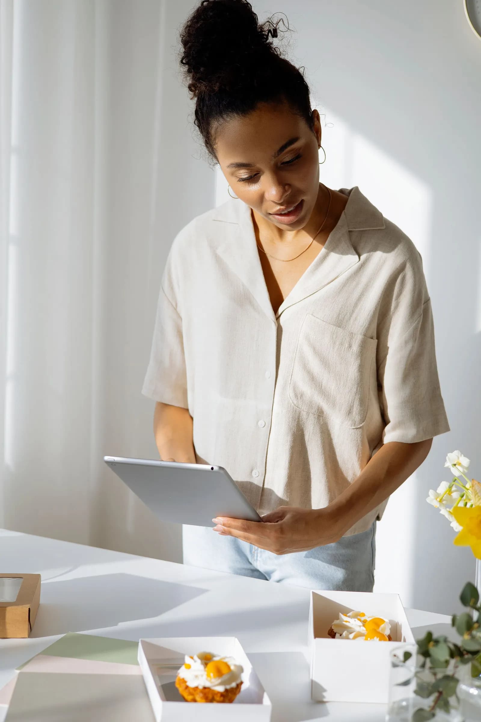 A business owner reviewing her website on a tablet